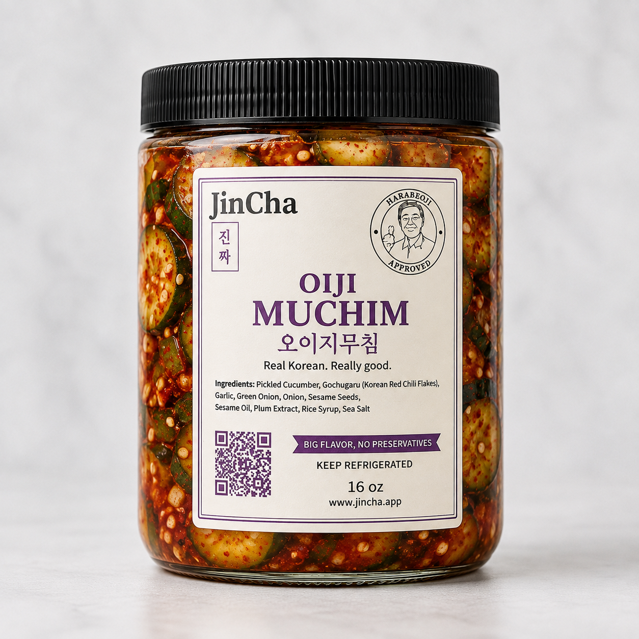 Jar of JinCha Oiji Muchim — seasoned Korean cucumber with gochugaru, sesame oil, garlic, and scallions, handcrafted in the Bay Area